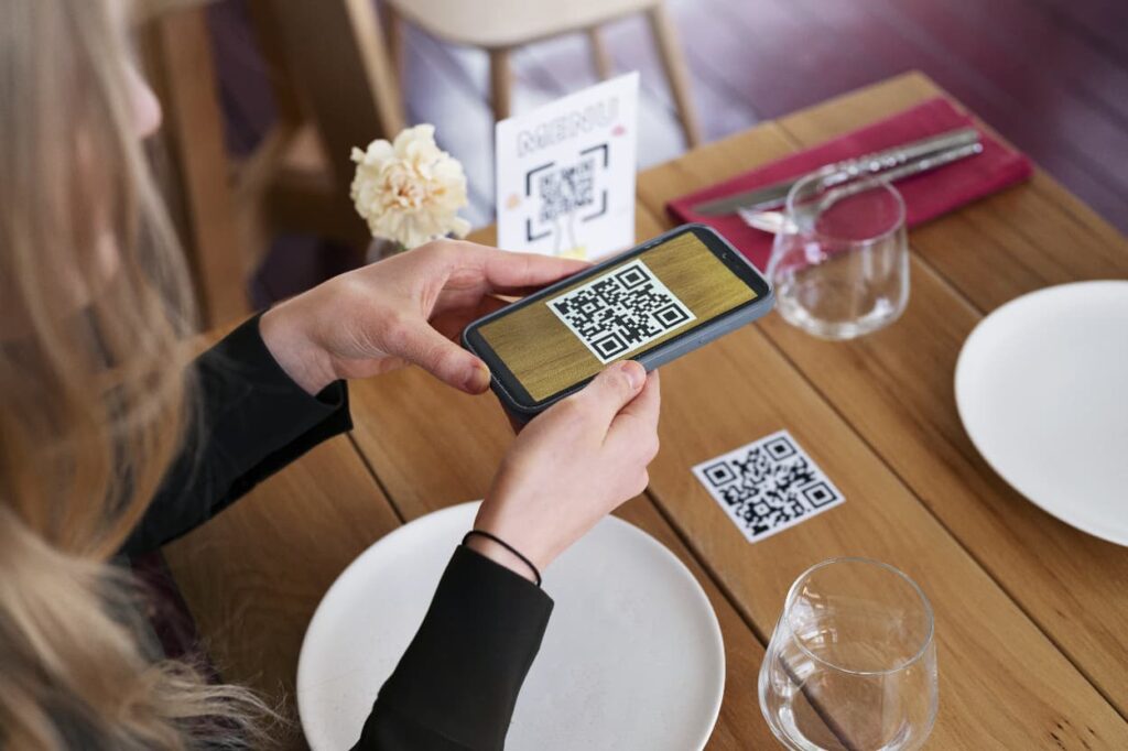 Woman scanning as QR for Instagram at a restaurant