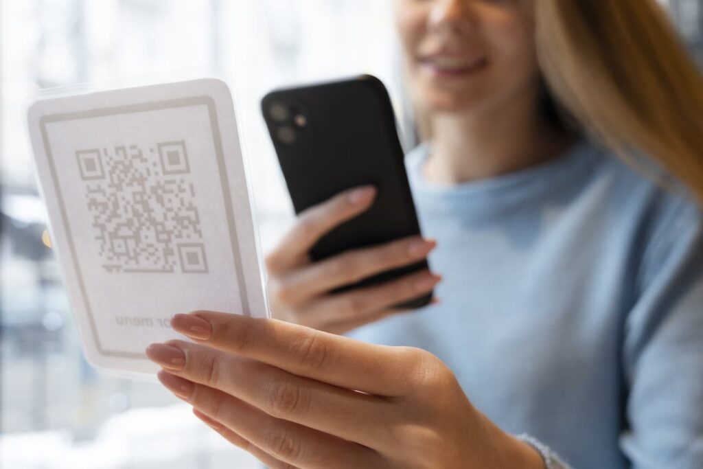 Woman scanning a QR code PNG format printed on paper
