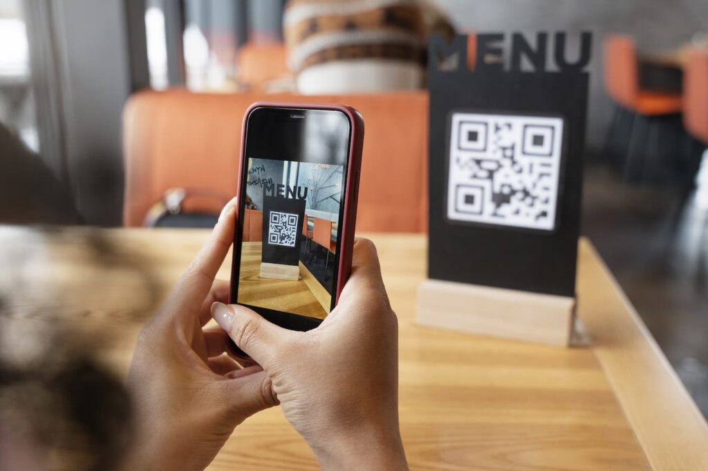 Woman scanning a QR code menu from close range with a smartphone camera
